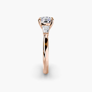 Three stone engagement ring setting in rose gold showing the band profile, with a round lab grown center diamond and tapered baguette side stones. || #metal_rose gold #diamond shape_round