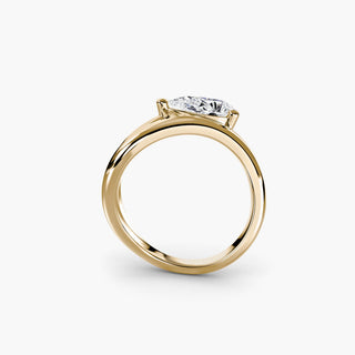 Wave lab grown diamond ring in yellow gold, side profile view showing the flowing wave band with a pear-shaped lab grown diamond. || #metal_yellow gold
