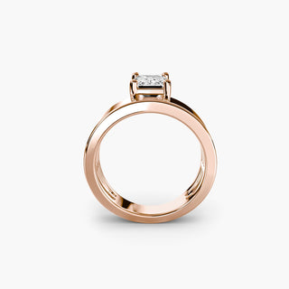 Solitaire engagement ring setting in rose gold, side profile view showing the wide band with an emerald-cut lab grown diamond. || #metal_rose gold
