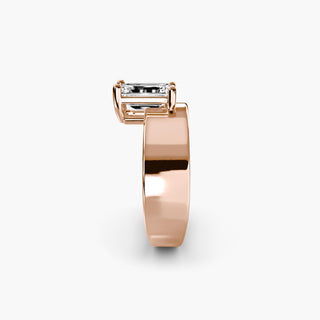 Solitaire engagement ring setting in rose gold showing the wide band profile with an emerald-cut lab grown diamond. || #metal_rose gold
