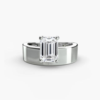 Solitaire engagement ring setting in white gold, featuring an emerald-cut lab grown diamond slightly offset above a sculptural wide band. || #metal_white gold|platinum