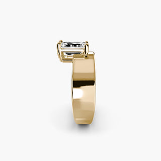 Solitaire engagement ring setting in yellow gold showing the wide band profile with an emerald-cut lab grown diamond. || #metal_yellow gold