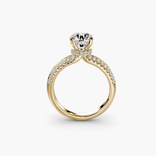 Gold knife-edge pavé engagement ring with round diamonds and hidden halo setting, showcasing intricate craftsmanship.