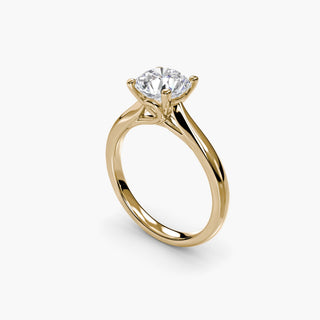 Solitaire engagement ring setting with a round lab grown diamond in yellow gold, three-quarter view showing the loop basket. || #metal_yellow gold #diamond shape_round