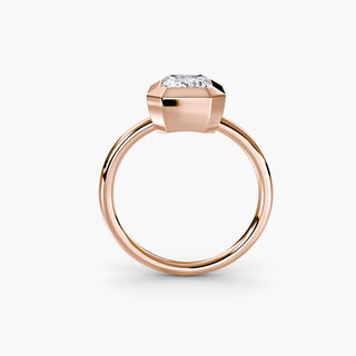 Bezel solitaire engagement ring setting in rose gold, side profile view with an emerald-cut lab grown diamond. || #metal_rose gold #diamond shape_emerald