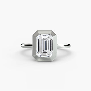 Bezel solitaire engagement ring setting in white gold, featuring an emerald-cut lab grown diamond in a smooth sculpted bezel. || #metal_white gold|platinum #diamond shape_emerald