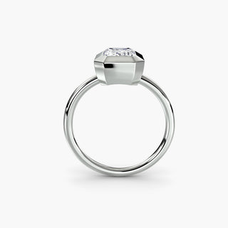 Bezel solitaire engagement ring setting in white gold, side profile view with an emerald-cut lab grown diamond. || #metal_white gold|platinum #diamond shape_emerald