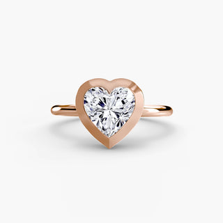 Bezel solitaire engagement ring setting in rose gold, featuring a heart-shaped lab grown diamond in a smooth sculpted bezel. || #metal_rose gold #diamond shape_heart