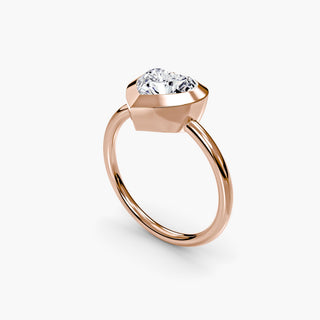 Bezel solitaire engagement ring setting in rose gold with a heart-shaped lab grown diamond, three-quarter view. || #metal_rose gold #diamond shape_heart