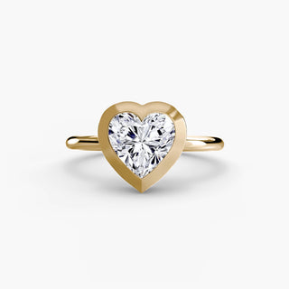 Bezel solitaire engagement ring setting in yellow gold, featuring a heart-shaped lab grown diamond in a smooth sculpted bezel. || #metal_yellow gold #diamond shape_heart