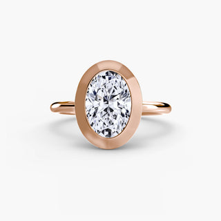 Bezel solitaire engagement ring setting in rose gold, featuring an oval-cut lab grown diamond in a smooth sculpted bezel. || #metal_rose gold #diamond shape_oval