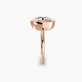 Bezel solitaire engagement ring setting in rose gold showing the band profile, with an oval-cut lab grown diamond. || #metal_rose gold #diamond shape_oval