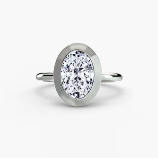 Bezel solitaire engagement ring setting in white gold, featuring an oval-cut lab grown diamond in a smooth sculpted bezel. || #metal_white gold|platinum #diamond shape_oval