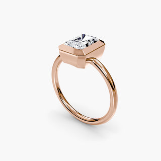 Bezel solitaire engagement ring setting in rose gold with a radiant-cut lab grown diamond, three-quarter view. || #metal_rose gold #diamond shape_radiant