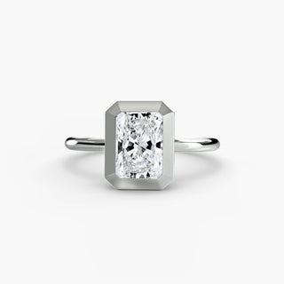 Bezel solitaire engagement ring setting in white gold, featuring a radiant-cut lab grown diamond in a smooth sculpted bezel. || #metal_white gold|platinum #diamond shape_radiant