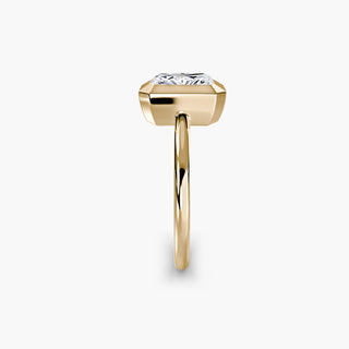 Bezel solitaire engagement ring setting in yellow gold showing the band profile, with a radiant-cut lab grown diamond. || #metal_yellow gold #diamond shape_radiant