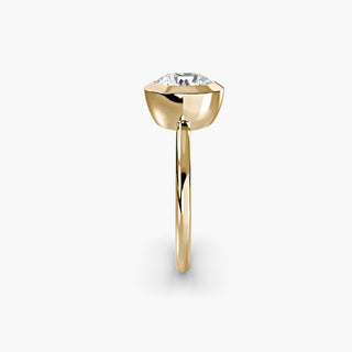 Bezel solitaire engagement ring setting in yellow gold showing the band profile, with a round lab grown diamond. || #metal_yellow gold #diamond shape_round