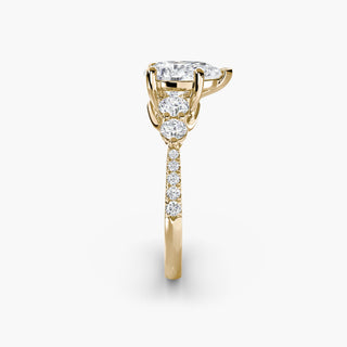 Five stone pavé trellis engagement ring setting with yellow gold band and pear-shaped diamonds, showcasing intricate metalwork details.