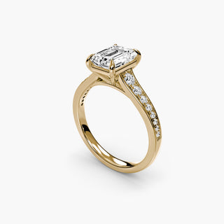 Reverse tapered channel set engagement ring with emerald-cut diamonds in yellow gold, showcasing a detailed side and angled view.