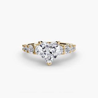 Gold lab-grown diamond engagement ring with a graduated round U-prong diamond band and heart-shaped design detail.