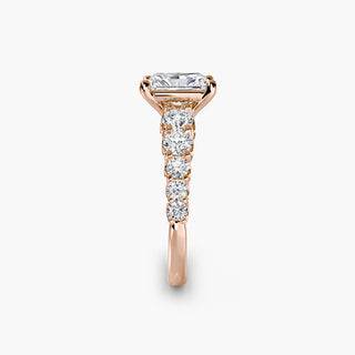 Graduated round U-prong diamond band engagement ring with radiant cut diamonds in a silver setting, showcasing side view.