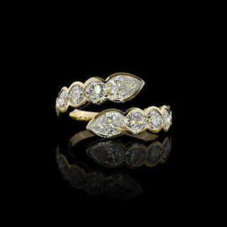 Lab-grown diamond bypass ring with pear and round bezel-set diamonds in yellow gold, 2.75 carats total weight.