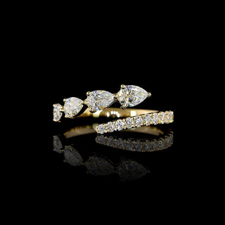 Lab grown diamond bypass wrap ring with east-west pear and round diamonds in 14k yellow gold prong setting, 1 carat total weight.