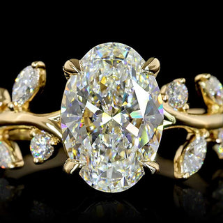 Oval lab-grown diamond engagement ring with marquise vine design in yellow gold, size 6.5, showcasing sparkling 2.5 to 3 carat total weight.