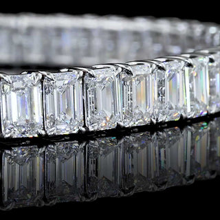 Emerald lab-grown diamond tennis bracelet with 12 carats total weight, set in white gold, featuring 22-point emerald-cut diamonds.