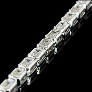 Lab Grown Diamonds 5 CTW emerald bezel tennis bracelet with east-west diamonds on a white gold 7-inch band.