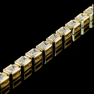 Lab Grown Diamonds 5 CTW emerald bezel tennis bracelet with east-west diamonds on yellow gold, 7-inch length.