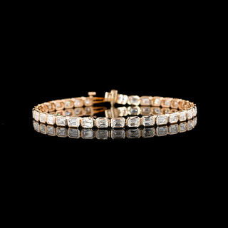 Lab-grown emerald bezel tennis bracelet with 7 carats total weight, east-west design, 7-inch length, featuring lab diamond accents.