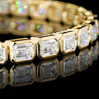 7 ct tw East-West emerald bezel lab-grown diamond tennis bracelet with yellow gold setting, 7-inch length, elegant jewelry piece.