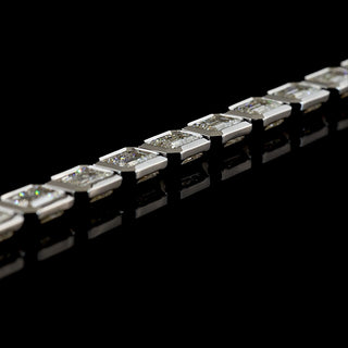 Side angle view of East-West Emerald-cut lab grown diamond tennis bracelet in 14k white gold, bezel setting, 10 carat total weight.