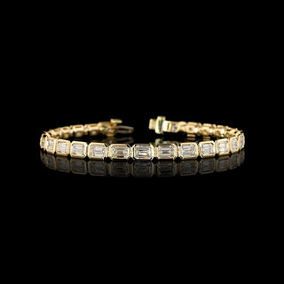 East-West Emerald-cut lab grown diamond tennis bracelet in 14k yellow gold, bezel setting, 10 carat total weight.