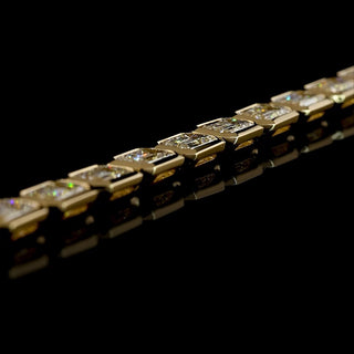 Side angle view of East-West Emerald-cut lab grown diamond tennis bracelet in 14k yellow gold, bezel setting, 10 carat total weight.