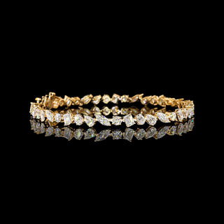 7 carat total weight mixed shape lab-grown diamond tennis bracelet in yellow gold, 7-inch length, sparkling and elegant.
