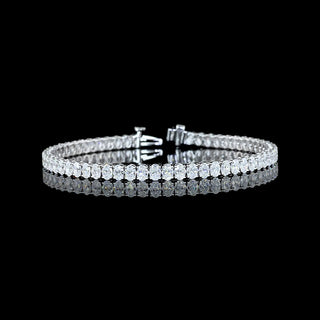 Oval lab-grown diamond tennis bracelet with 7 carats total weight in white gold, 7-inch length, featuring 12-point diamonds.