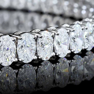 Oval lab-grown diamond tennis bracelet with 7 carats total weight in white gold, 7-inch length, featuring sparkling 12-point diamonds.