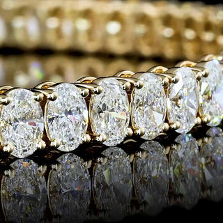 Gold oval lab-grown diamond tennis bracelet with 7 carats total weight and 12pt diamonds, 7-inch length.