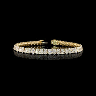 Oval lab-grown diamond tennis bracelet with 10 carats total weight and yellow gold setting, featuring sparkling oval-cut diamonds.