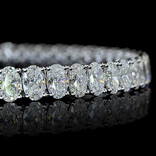 Close-up of Oval lab grown diamond tennis bracelet in 14k white gold, 25-pointer diamonds in prong setting, 12 carats total. 
