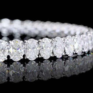 Oval lab-grown diamond tennis bracelet with 15 carats total weight, 42 diamonds, white gold setting, 7-inch length.
