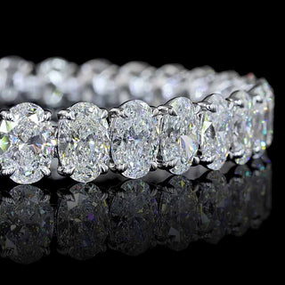 Close-up of Oval lab grown diamond tennis bracelet in 14k white gold, with 70 to 75-pointer oval diamonds set in claw prongs.