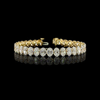 Oval lab grown diamond tennis bracelet in 14k yellow gold, prong setting, 25 carats total.