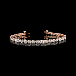 Oval lab-grown diamond tennis bracelet with east-west design and 5 carats total weight, 7-inch length, in a vibrant rose gold setting.