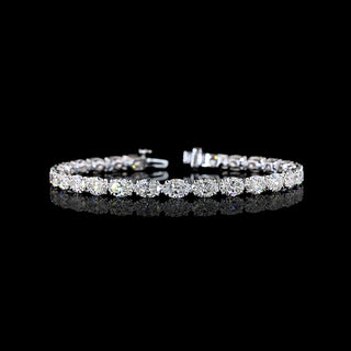 East-West oval lab grown diamond tennis bracelet, 50-pointer (half carat each) diamonds in a claw prong setting, 12 carats total. 