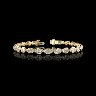 East-West Oval lab grown diamond tennis bracelet in 14k yellow gold, bezel setting, 10 carats total.