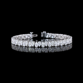 Alternating pear-shaped lab-grown diamond tennis bracelet with 11 carats total weight in white gold.