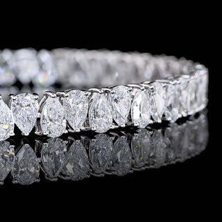 Elegant tennis bracelet with alternating pear-shaped lab-grown diamonds totaling 11 carats, set in white gold.